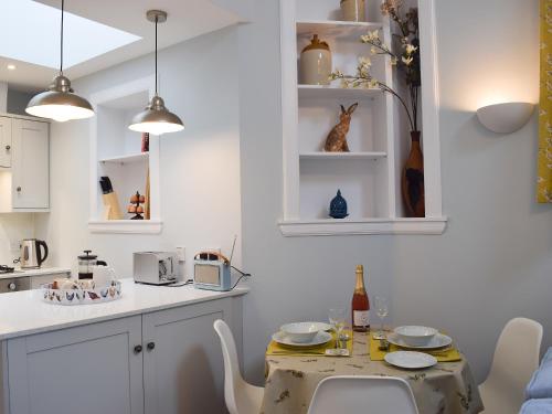 a kitchen with a table and chairs in a room at The Old Stables At Westerton in Crieff