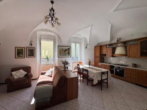 a large living room with a couch and a table at Cà du lac in Dervio