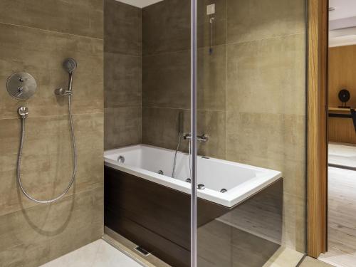 a bathroom with a shower with a bath tub at Ibis Styles Heraklion Central in Heraklio Town