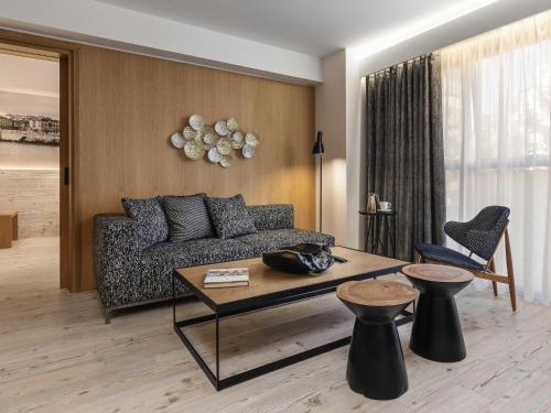 a living room with a couch and a table at Ibis Styles Heraklion Central in Heraklio Town