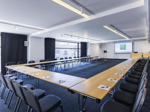 a large conference room with a long table and chairs at Ibis Styles Heraklion Central in Heraklio Town