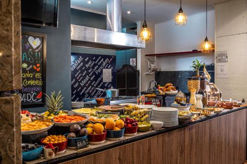 a buffet line with a lot of fruits and vegetables at 84 DC Bogotá By OxoHotel in Bogotá