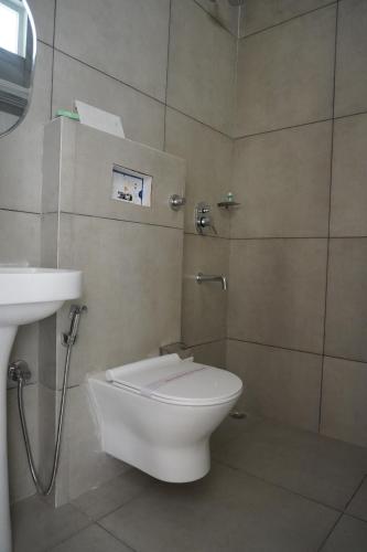 a bathroom with a toilet and a sink at 7Sky Hotel and Restaurant in Bhojpur