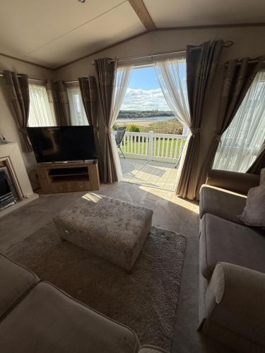 a living room with a couch and a flat screen tv at Sandy Bay- No38 The Waterfront in North Seaton