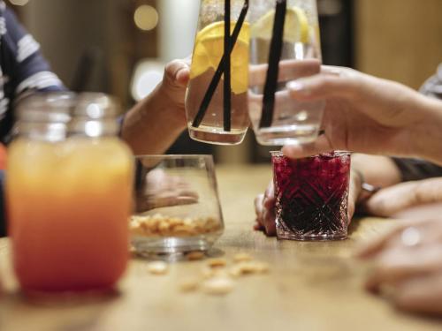 a group of people sitting at a table with drinks at Mercure Hotel Mannheim am Friedensplatz in Mannheim