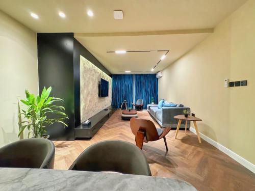 a living room with a couch and a tv at Qlets Privé in Abuja