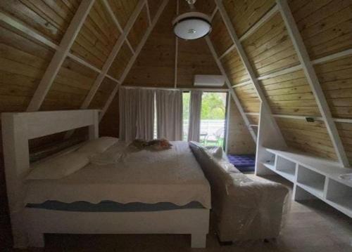 a bedroom with a bed in a wooden attic at Villa Machepa 
