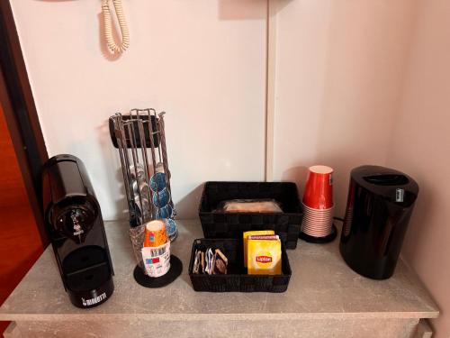 a counter top with a coffee maker and other items at Del Console Apartment - Near Bari Airport & Station in Modugno
