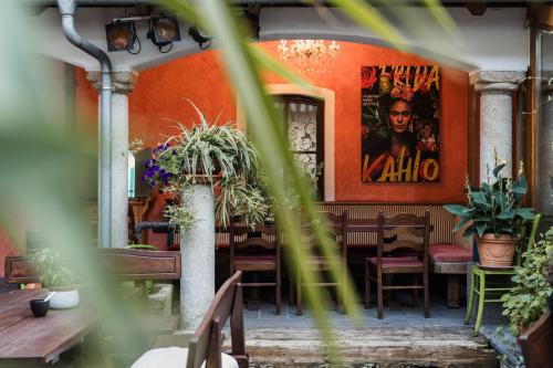 a restaurant with orange walls and tables and plants at Lindengut Natternbach in Natternbach