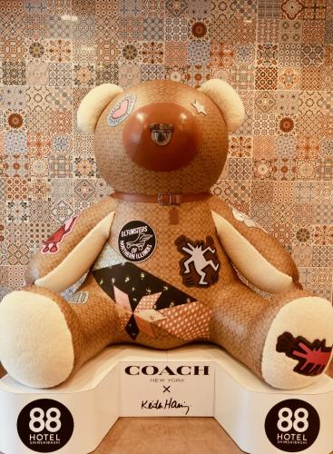 a stuffed teddy bear sitting on a table at Hotel 88 Shinsaibashi in Osaka