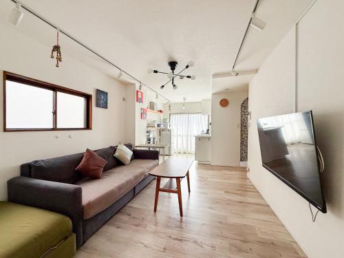 a living room with a couch and a table at Gallery House in Tokyo
