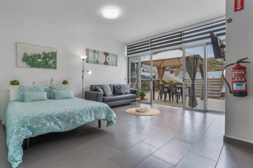 a bedroom with a bed and a living room at Casa Alsa in La Guancha