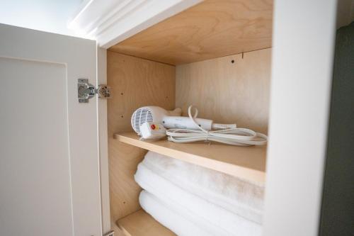 a room with a shelf with a fan and towels at The Golden Tiger in Baton Rouge