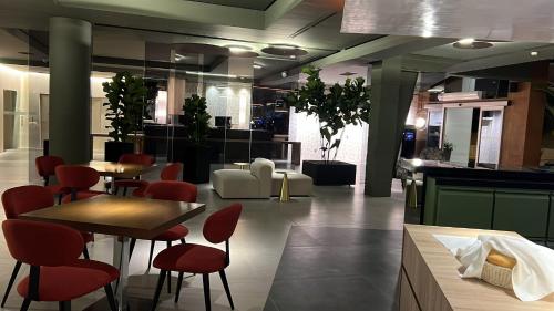 a restaurant with tables and chairs in a room at Spa Jardines de Lorca in Lorca