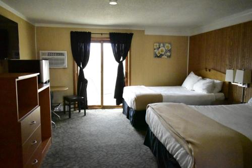 a hotel room with two beds and a window at Hampton Motel in Hampton