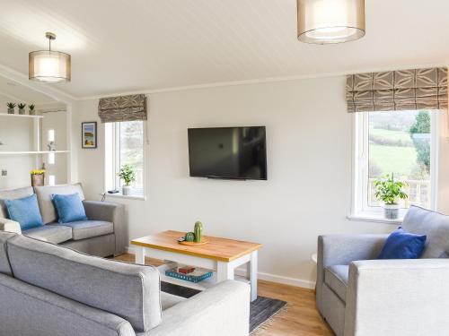 a living room with two couches and a tv at The View - Uk36812 in Whalley