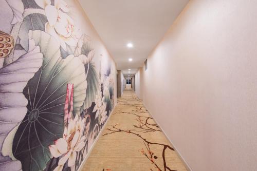 a hallway with a mural of flowers on the wall at Foshan Xingdu International Hotel in Foshan