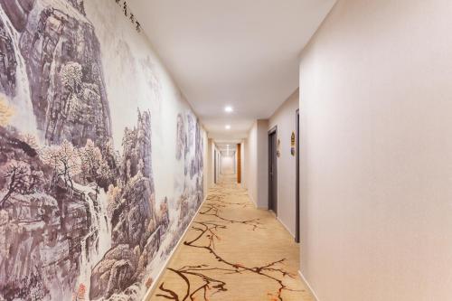 a hallway with paintings on the walls of a building at Foshan Xingdu International Hotel in Foshan