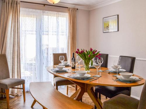 a dining room with a wooden table and chairs at The Sandpiper in Filey