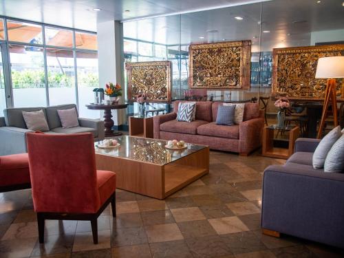 a living room with couches and a coffee table at San Agustin Exclusive in Lima