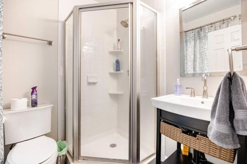a bathroom with a shower and a sink at Cozy 3 bedroom and 2 bath Townhouse in Arlington
