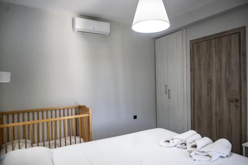 a bedroom with two beds with towels on them at Hill Sun Luxury Suites in Nea Iraklia