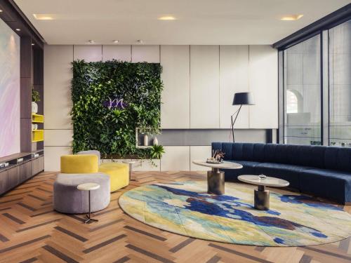 a living room with a couch and a rug at Mercure Shanghai Hongqiao South in Shanghai