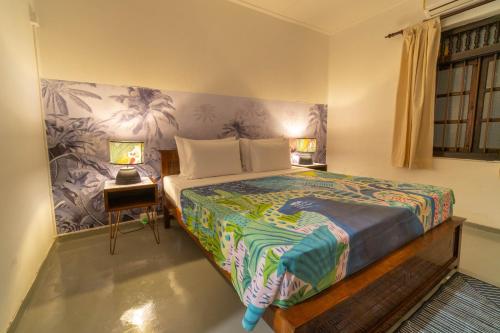 a bedroom with a bed and a table with two lamps at Bird Of Paradise - Ahangama Villa in Ahangama