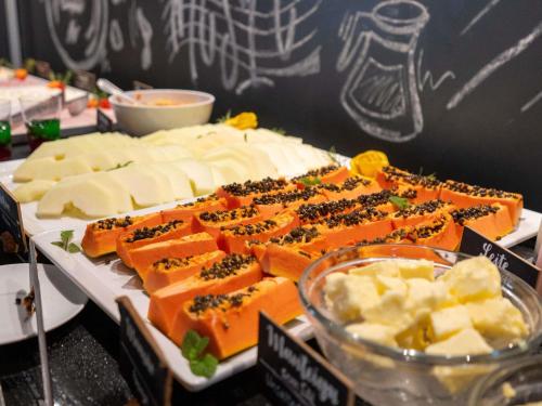 a tray of cheese and other foods on a table at ibis Styles Taubate in Taubaté