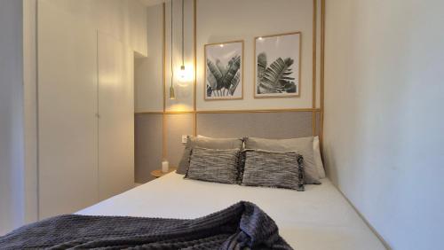 a bedroom with a bed with two pillows at 5 Dragos Suites in La Orotava