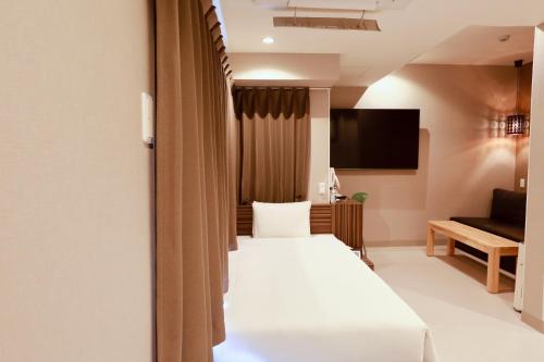 a hotel room with a bed and a couch at Hotel 88 Shinsaibashi in Osaka