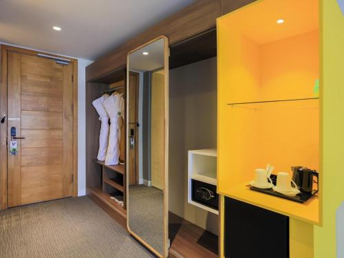 a dressing room with a mirror and a closet at IBIS Styles Ulaanbaatar Polaris in Ulaanbaatar