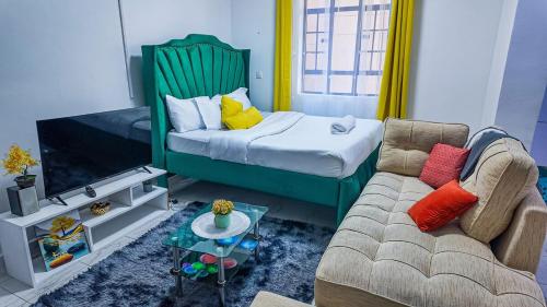 a living room with a bed and a couch at Studio 107,Sana Sana, South B, Off Mombasa Road in Nairobi