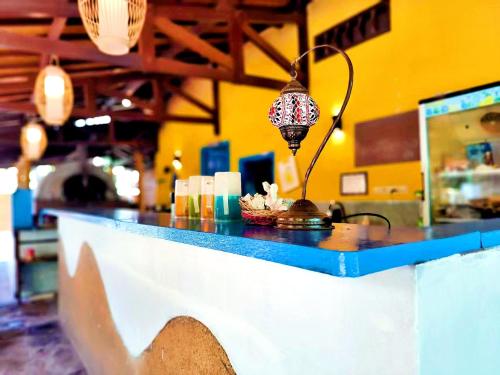 a counter in a restaurant with a light on it at Oasi Bungalow Gili Air in Gili Islands