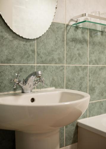 a bathroom with a sink and a mirror at Blue Ball Inn in Lynmouth