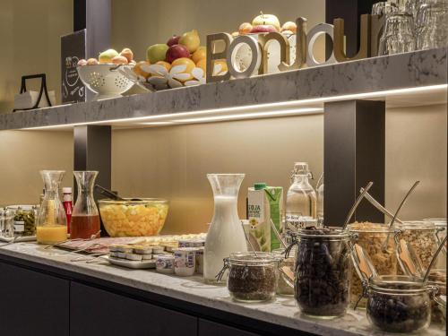 a kitchen counter with a bunch of ingredients on it at Ibis Styles Toulouse Capitole in Toulouse