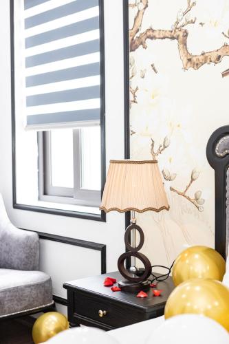 a lamp sitting on a table in a bedroom at Royal Lotus Hotel in Hanoi