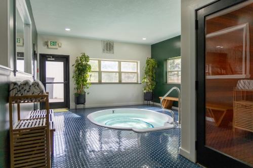 a large bathroom with a tub in the middle of a room at The Fold Hotels Steamboat Springs in Steamboat Springs