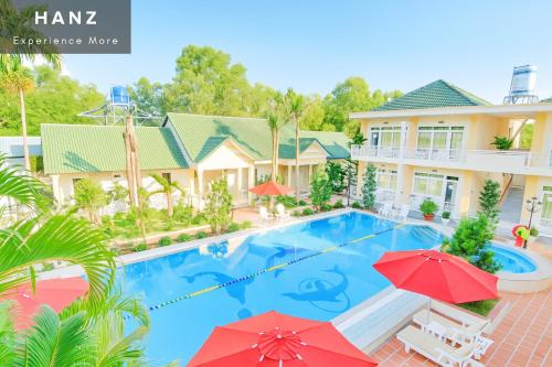 an image of a house with a swimming pool and red umbrellas at S79 Blue Paradise Lam Ha Pool in Phu Quoc