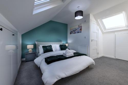 エディンバラにあるElegant 4BR Home, Parking, City Centre, Sleeps7の青い壁の大きなベッドのある寝室
