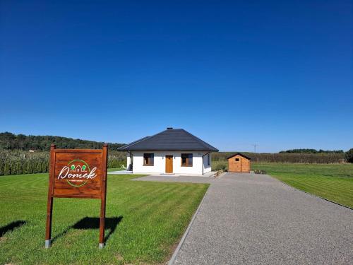 a coca cola sign in front of a house at Domek wśród Jabłonek in Łoniów