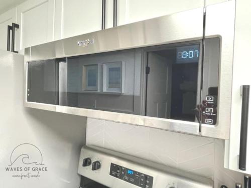 a microwave oven in a kitchen with at Waves of Grace Apartment Oceanfront SeaWatch Resort in Myrtle Beach