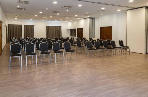 a room with rows of chairs in a hall at Wyndham Garden Luján in Luján