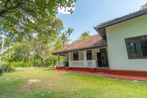 a house with a yard in front of it at Bird Of Paradise - Ahangama Villa in Ahangama