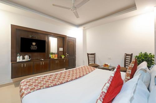 a bedroom with a bed and a television in it at Hotel Tela Family stay Near IGI Airport Delhi 