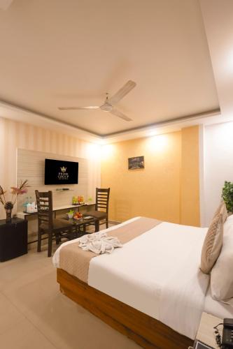 a bedroom with a bed and a table and a desk at Hotel Tela Family stay Near IGI Airport Delhi 