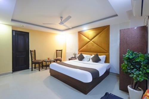 a hotel room with a bed and a table at Hotel Tela Family stay Near IGI Airport Delhi 