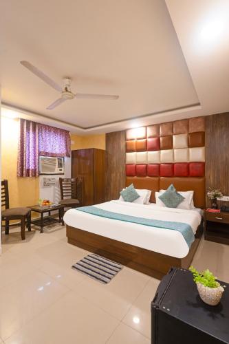 a bedroom with a large bed in a room at Hotel Tela Family stay Near IGI Airport Delhi 