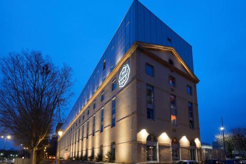 a building with a clock on the side of it at The Social Hub Toulouse Extended Stay in Toulouse