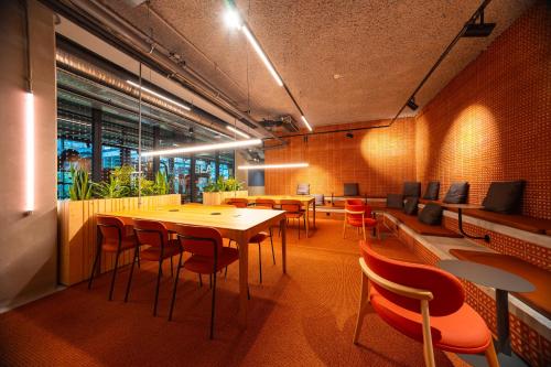 a restaurant with tables and chairs in a room at The Social Hub Toulouse Extended Stay in Toulouse